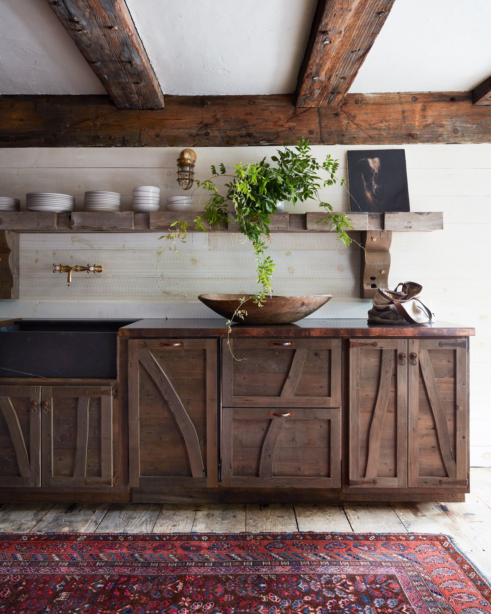 The kitchen features custom cabinetry and shelving.nbsp
